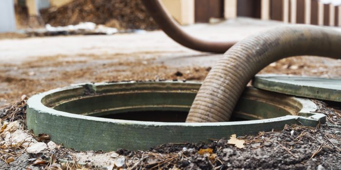 Pipe In The Drainage Pit. Pumping Out Sewage From A Septic Tank. Septic Tank Service